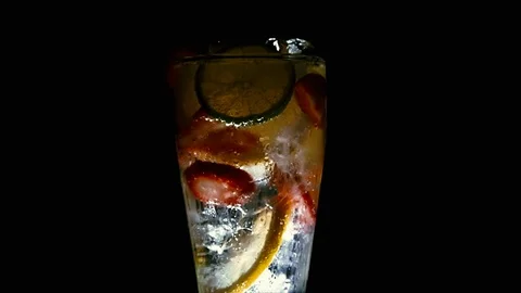 MEDIUM SHOT ROTATING STRAWBERRY LEMON LIME SODAWATER BOTTOM LIT 動画素材 93972842