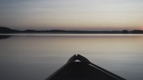 Medium shot of a rowboat during a sunset on a lake in Finland Stock Footage 113865124