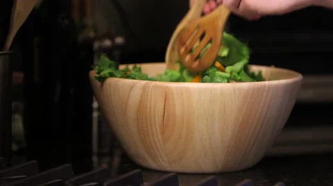 Medium shot of salad being tossed Stock Footage 61404356