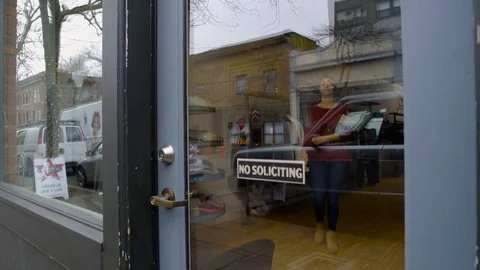 Medium shot of a sales worker opening a shop 動画素材 76215790