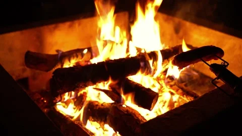 Medium shot of sausage over fire with oil dripping Stock Footage 134825492