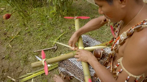 Medium shot showing an indigenous man wearing traditional outfit who is trying Stock Footage 113180022