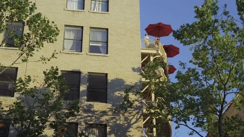 Medium shot of side of a building and tourists standing on the balcony Stock Footage 103422505