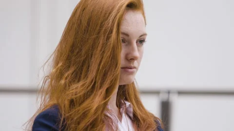 Medium shot side view of amused young female entrepreneur holding digital tablet Stock Footage 278011231