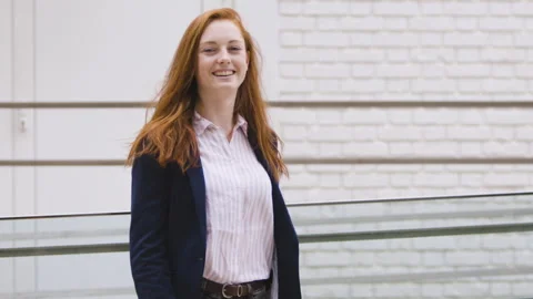 Medium shot side view of amused young female entrepreneur holding digital tablet Stock Footage 278011322