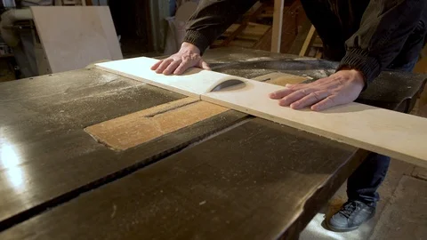 Medium shot side view of mature furniture maker using circular saw to make cuts Stock-Footage 107612744