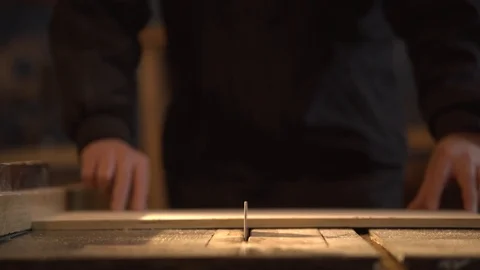 Medium shot side view of mature furniture maker using circular saw to make cuts Видео 107613111