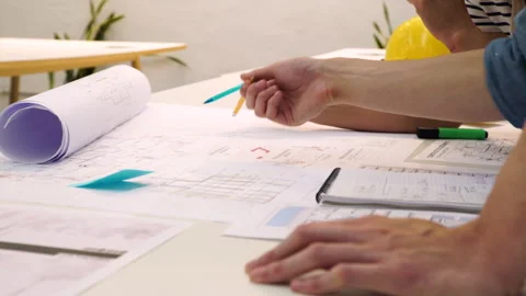 Medium shot side view of unidentified architects inspecting blueprints Stock Footage 277955962