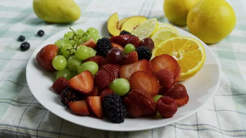 Medium shot of sliced fruit on plate in kitchen Stock Footage 341214213