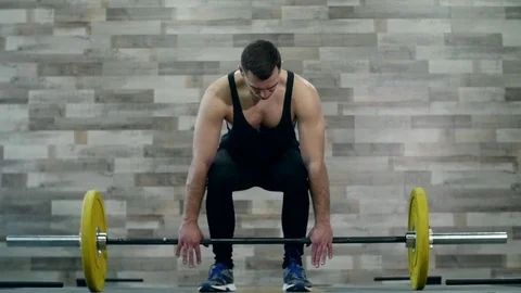 Medium shot slow mo tilt-down tilt-up men exercising and lifting weights female Stock Footage 74284100