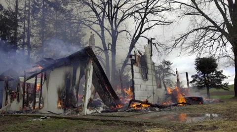 Medium shot of smoldering house Stock Footage 61180743