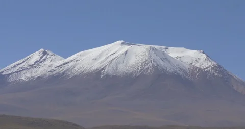Medium shot of snow capped volcano in the Bolivian desert Stock-Footage 87753539