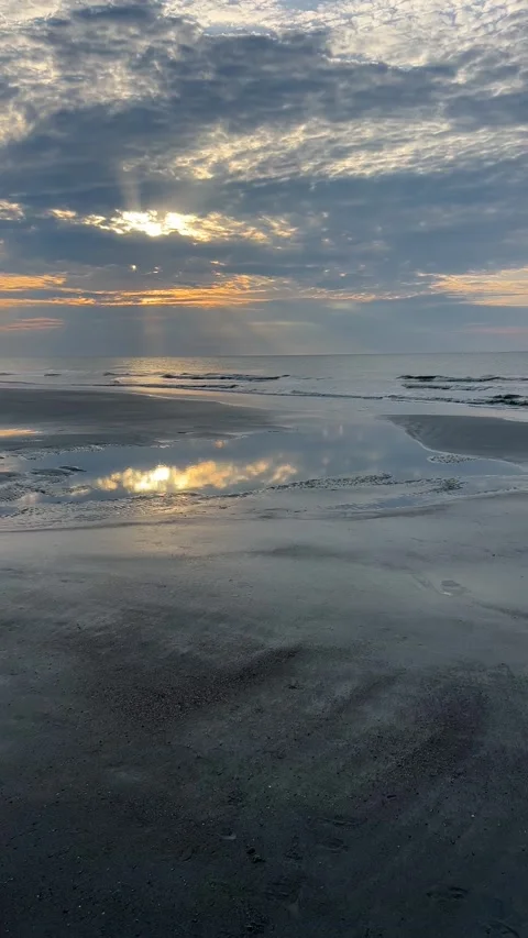 Medium shot of some puddles at the beach during sunrise Stock Footage 196928212