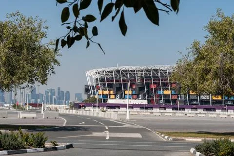 Medium shot of Stadium 974 container architecture framed by trees. 库存照片