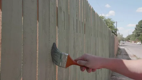 Medium shot Staining Fence with Paintbrush Stock Footage 80163045
