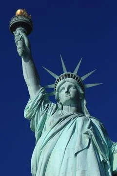 Medium shot of the statue of liberty and clear blue sky Stock Photos