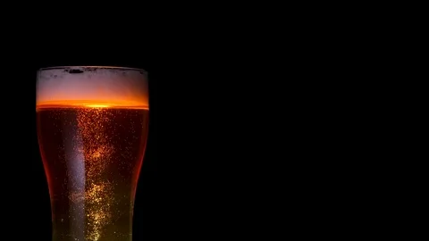 Medium shot stream of glass bocal of beer with many air bubbles rising up Stock Footage 103550686