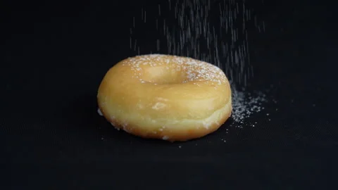 Medium shot strew icing sugar on donut 库存影片 135861106
