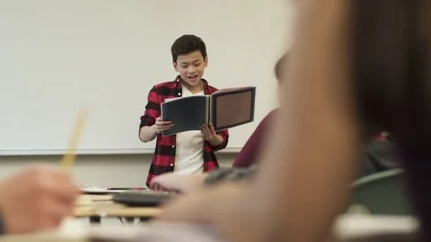 Medium shot of student presenting to class 動画素材 73303807