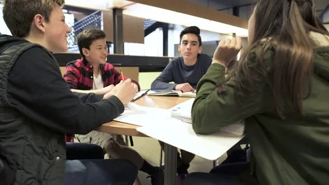 Medium shot of student sitting around a table 動画素材 73304597