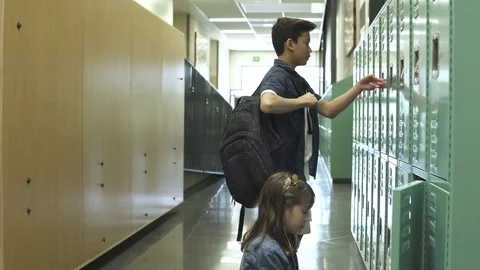 Medium shot of students opening lockers 動画素材 76553965