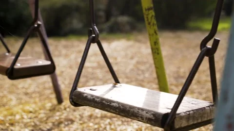 Medium shot of swing moving alone during autumn, Zagreb, Croatia. Stock Footage 145966689