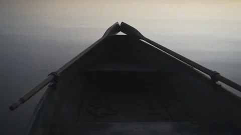 Medium shot of the tail end of a rowboat on a lake in Finland. Stock Footage 113864882