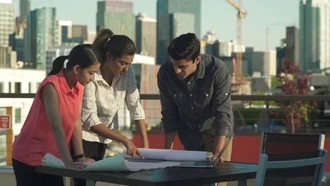 Medium shot of three people looking at a plan Stock-Footage 76235589
