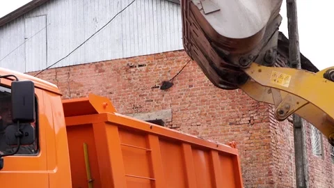 Medium shot. The tractor loads the rubble into the truck. Stock Footage 196087747