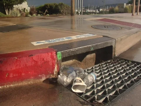 Medium shot of trash on a storm drain Video stock 609916