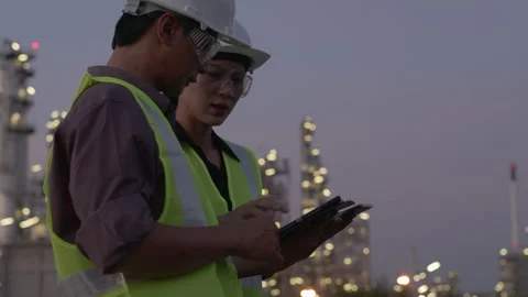 Medium shot. two Asian engineers using tablet working Stock Footage