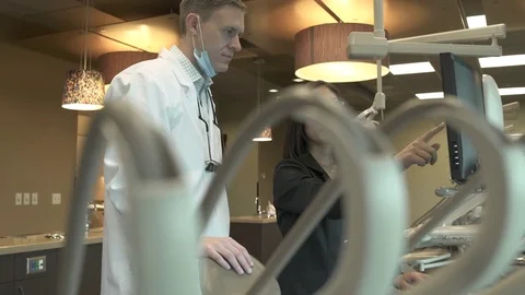 Medium shot of two dentists looking at a monitor Video stock 76217499