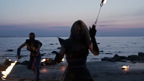 Medium shot of two fire dancers performing their piece Stock Footage 144681287