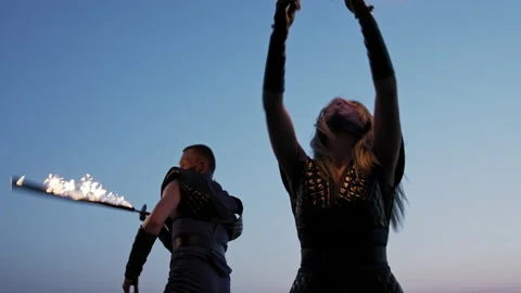 Medium shot of two fire dancers performing their piece Stock Footage 144683448