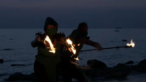 Medium shot of two fire dancers performing their piece Stock Footage 144684119