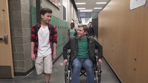 Medium shot of two friends chatting on school corridor Stock Footage 73293097