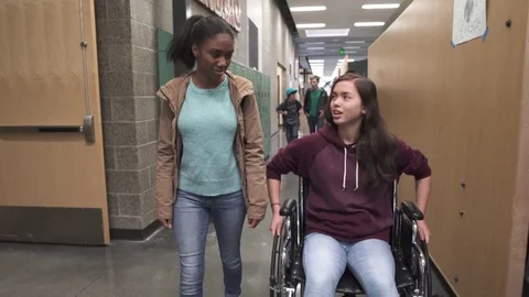 Medium shot of two friends chatting on school corridor 動画素材 73300032