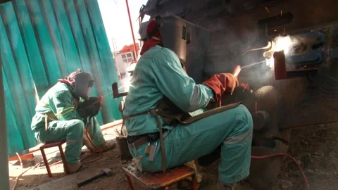 A medium shot of two men welding Stock Footage 312400411