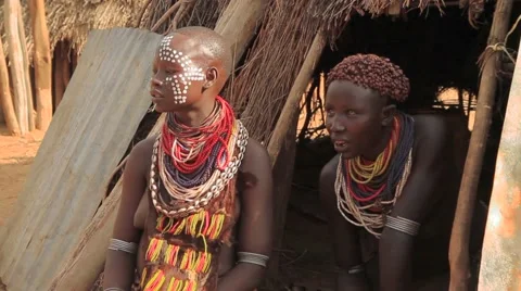 Medium Shot of Two Omo Valley Tribe Members In Their Hut Stock Footage 66357877