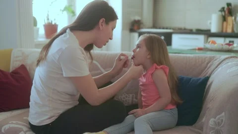 Medium Shot Two People Mother Applying Red Lipstick To Daughter Lips Stock-Footage 333190332