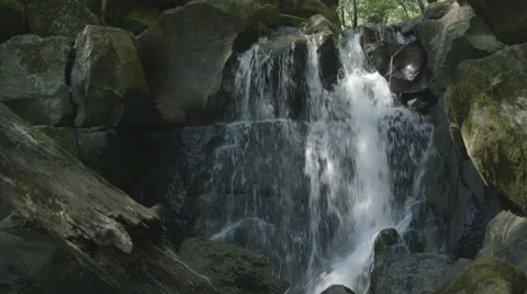 Medium shot of waterfall flowing over boulders. Stock Footage 39218145