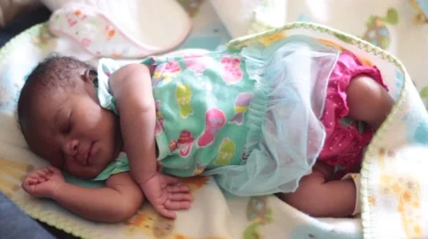 Medium Shot of  Week old baby Girl in Blue Dress Sleeping Stock Footage 61773209