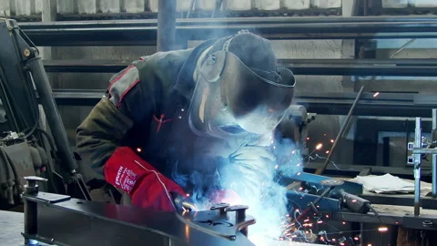 Medium shot of a welder in a protective mask and gloves in the welding process. Stock Footage 158789161