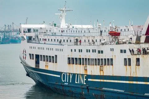 A medium shot of a white and blue city line ferry boat with people on its d.. Fotos de archivo