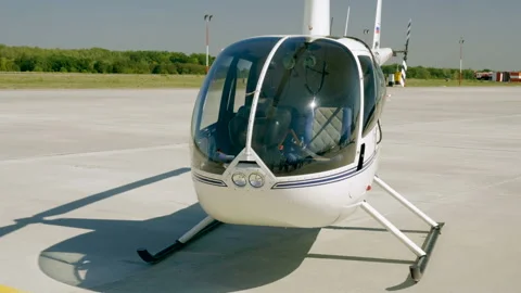Medium shot of white helicopter located at the airport. 4K Stock Footage 94953498