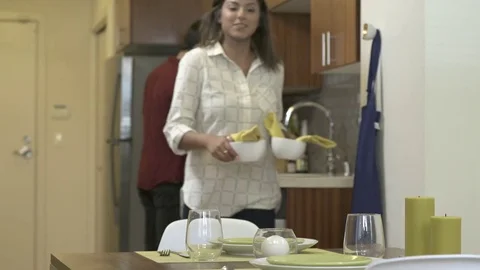 Medium shot of a woman setting a table 動画素材 76235353
