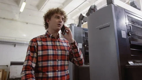 Medium shot of worker of printing house walking along corridor in industrial Stock Footage 110797962