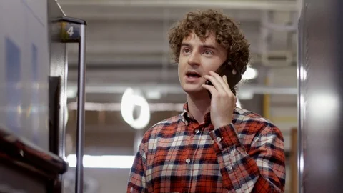 Medium shot of worker of printing house standing along corridor in industrial Stock Footage 110798448