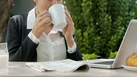 Medium shot of young attractive professional woman reading the newspaper and mul Stock Footage 199634868