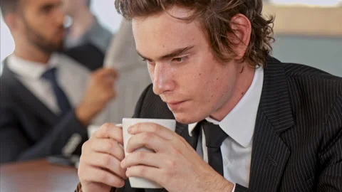Medium shot of young business man enjoying his coffee break and thinking wile dr Stock-Footage 199633976
